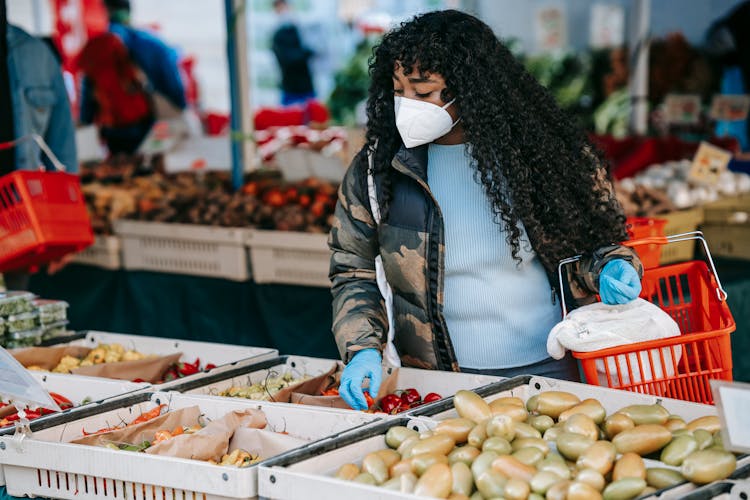 Black Woman Choosing Vegetables In Supermarket