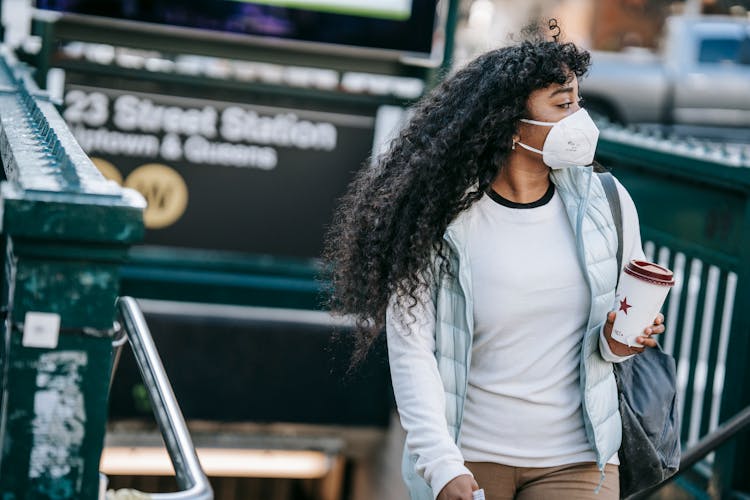 Black Woman With Takeaway Coffee Leaving Metro Station