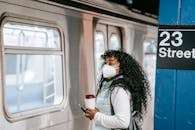 Black woman waiting for train on underground platform