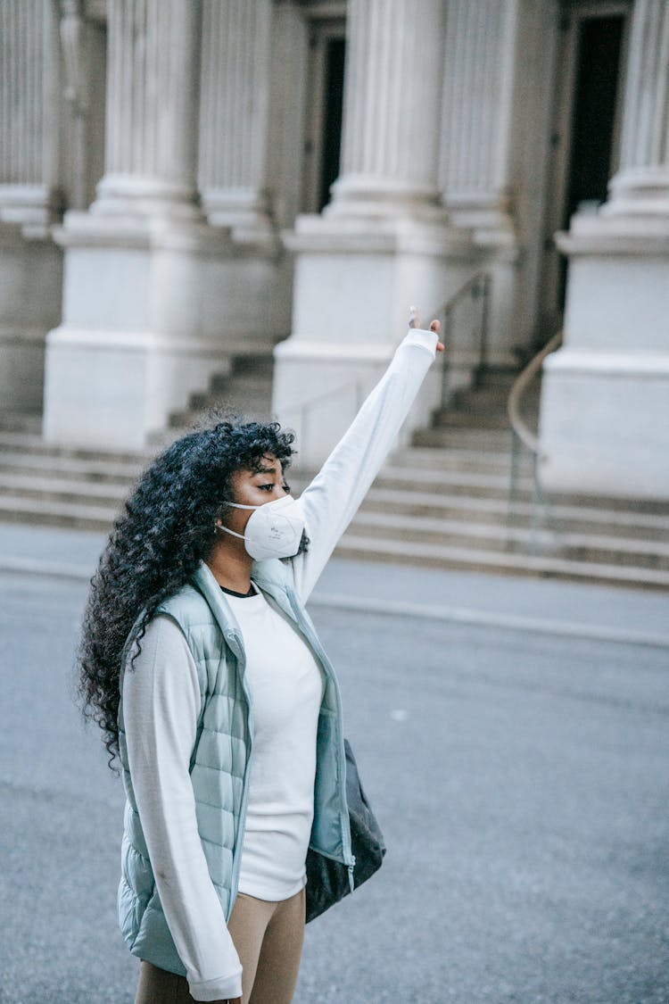 Young Black Woman Catching Cab On City Street