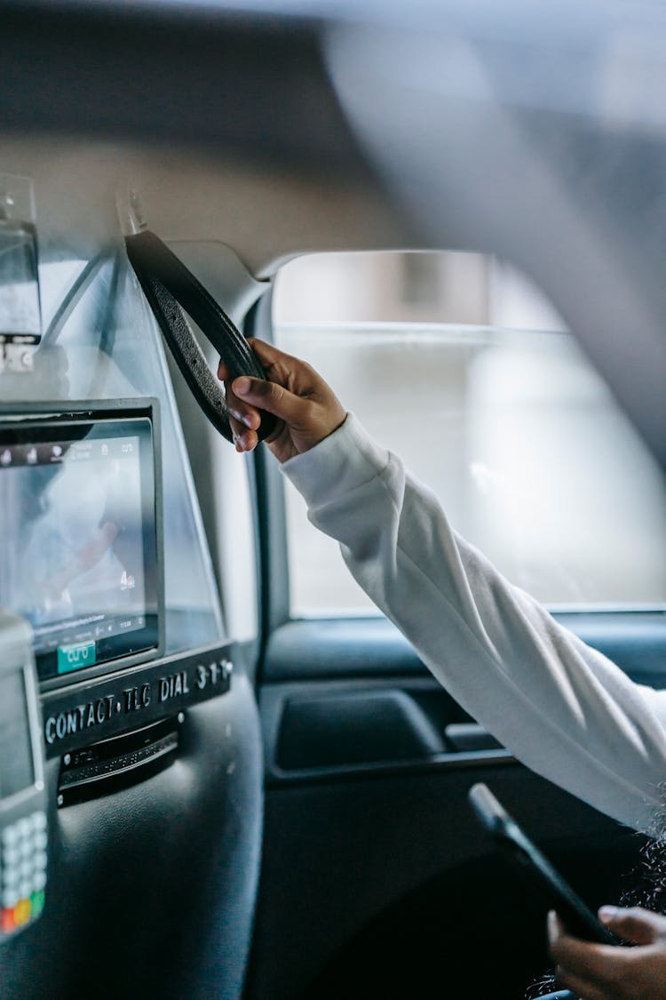 Unrecognisable Black Woman Using Smartphone In Taxi