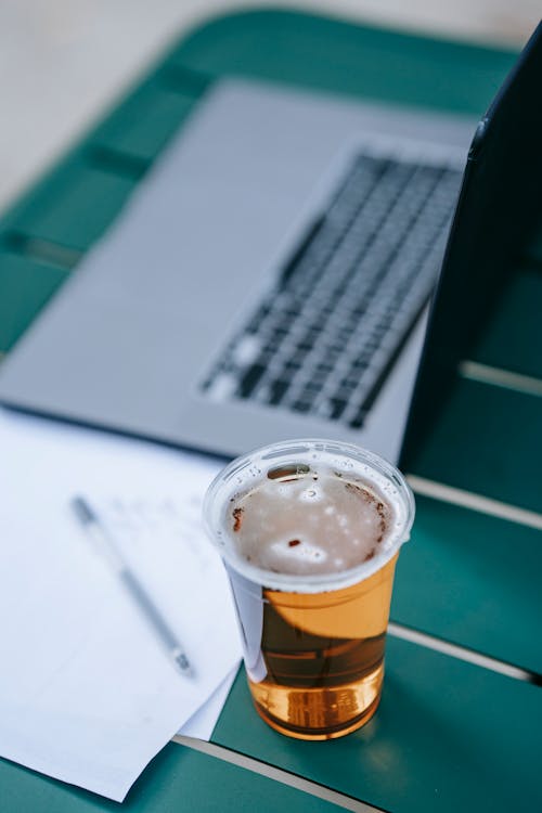 Table with laptop and glass of beer