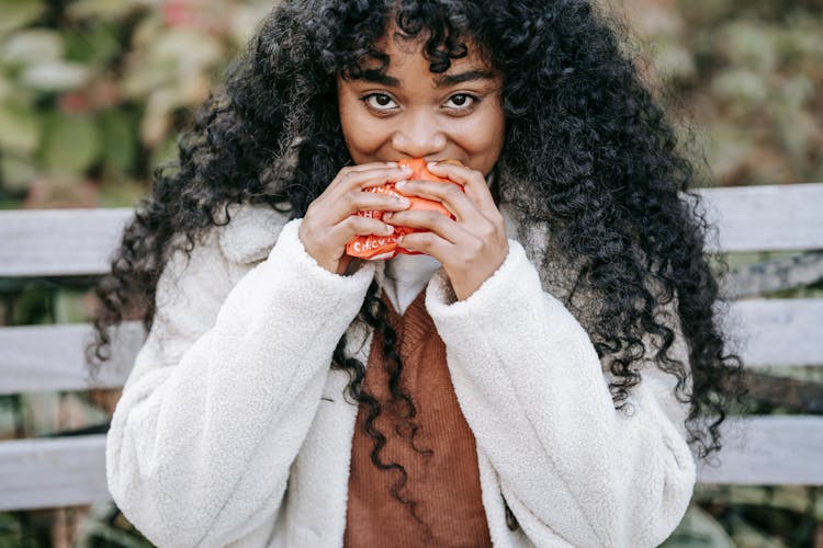 Crop Content Black Woman Eating Yummy Burger In Park