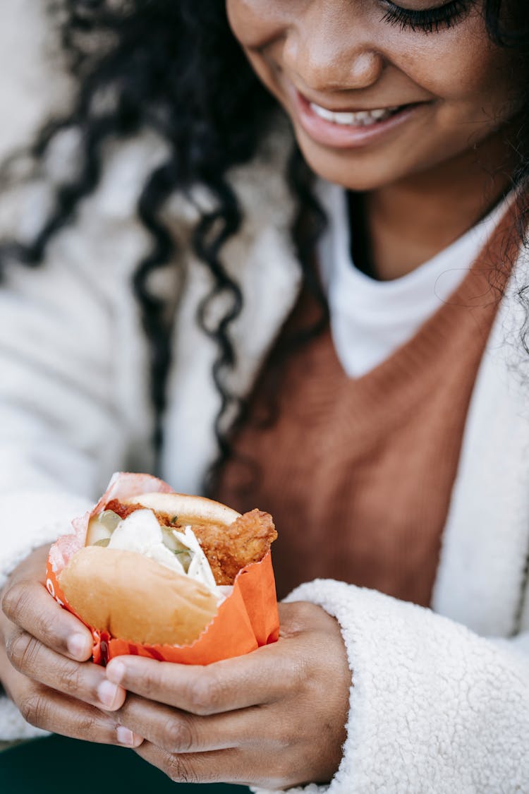 Crop Cheerful Black Woman Eating Tasty Burger