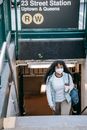 Black woman in respirator leaving metro station