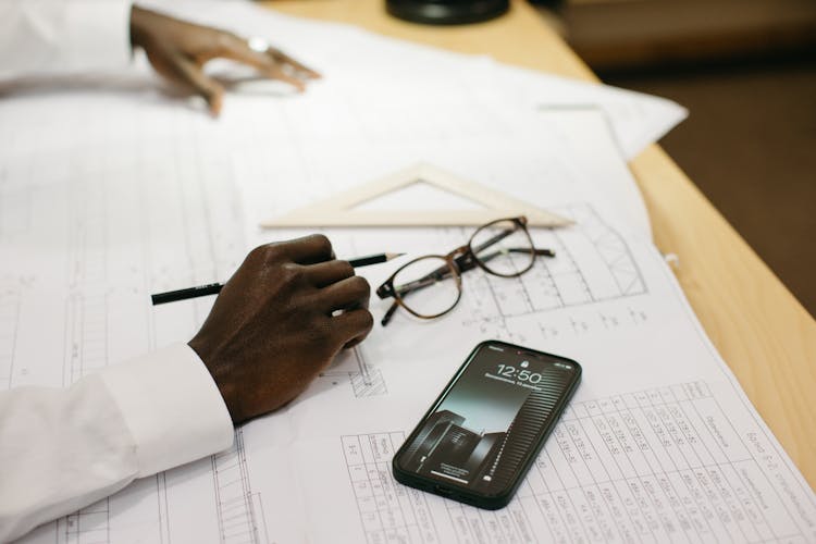 A Person Drafting On Paper