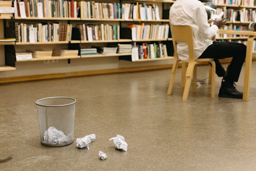 Crumpled Papers in the Trash Can and the Floor