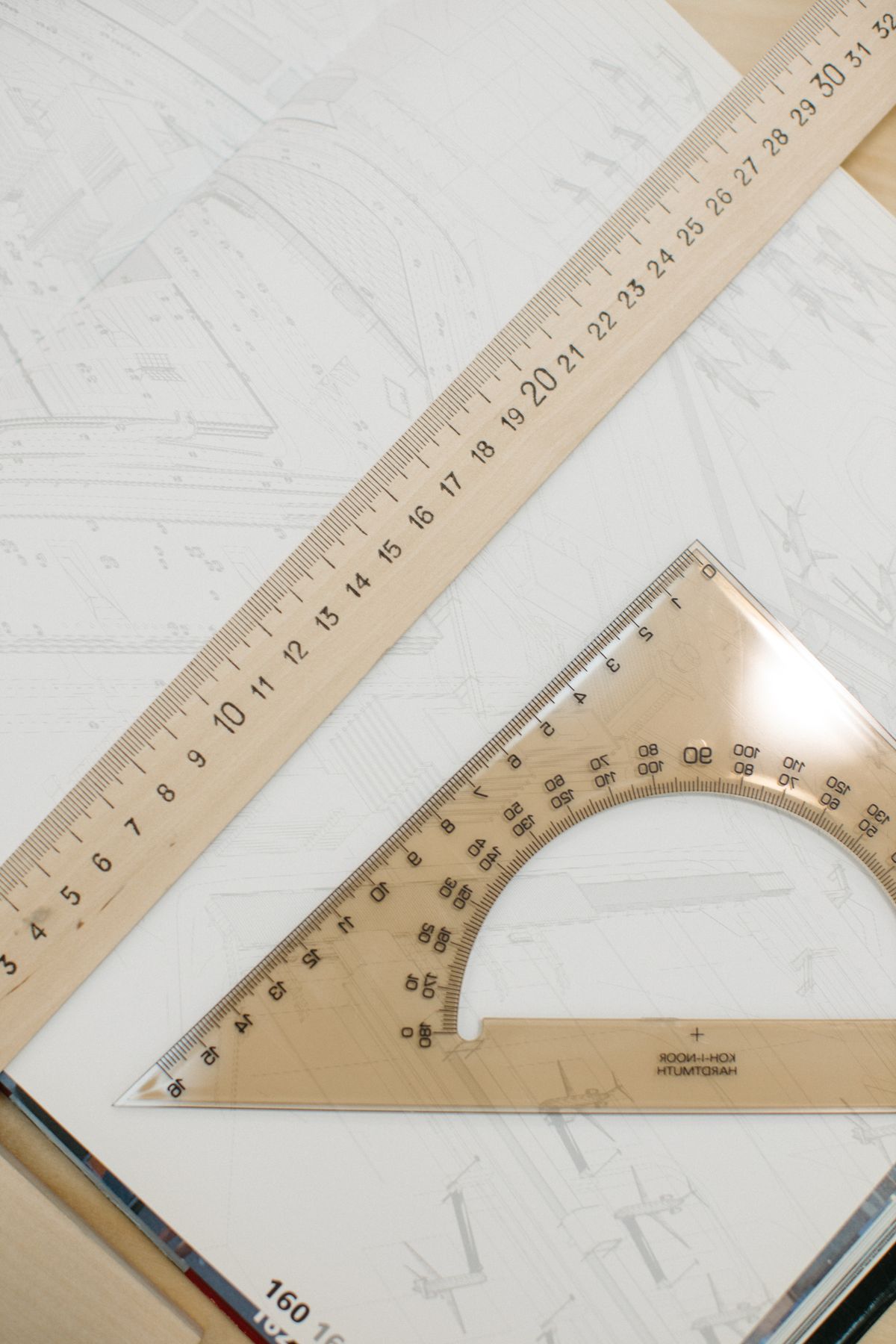 Architectural blueprint with a ruler and protractor on a desk