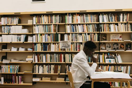 Man studying in a library, photo by Yaroslav Shuraev on Pexels