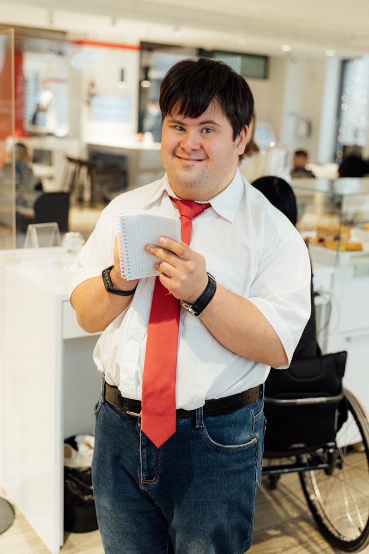 A Man Holding A Notepad