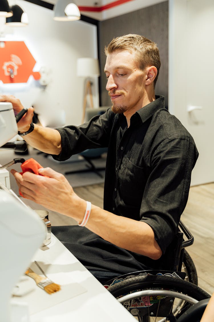 A Barista Cleaning The Steam Wand Of An Espresso Machine