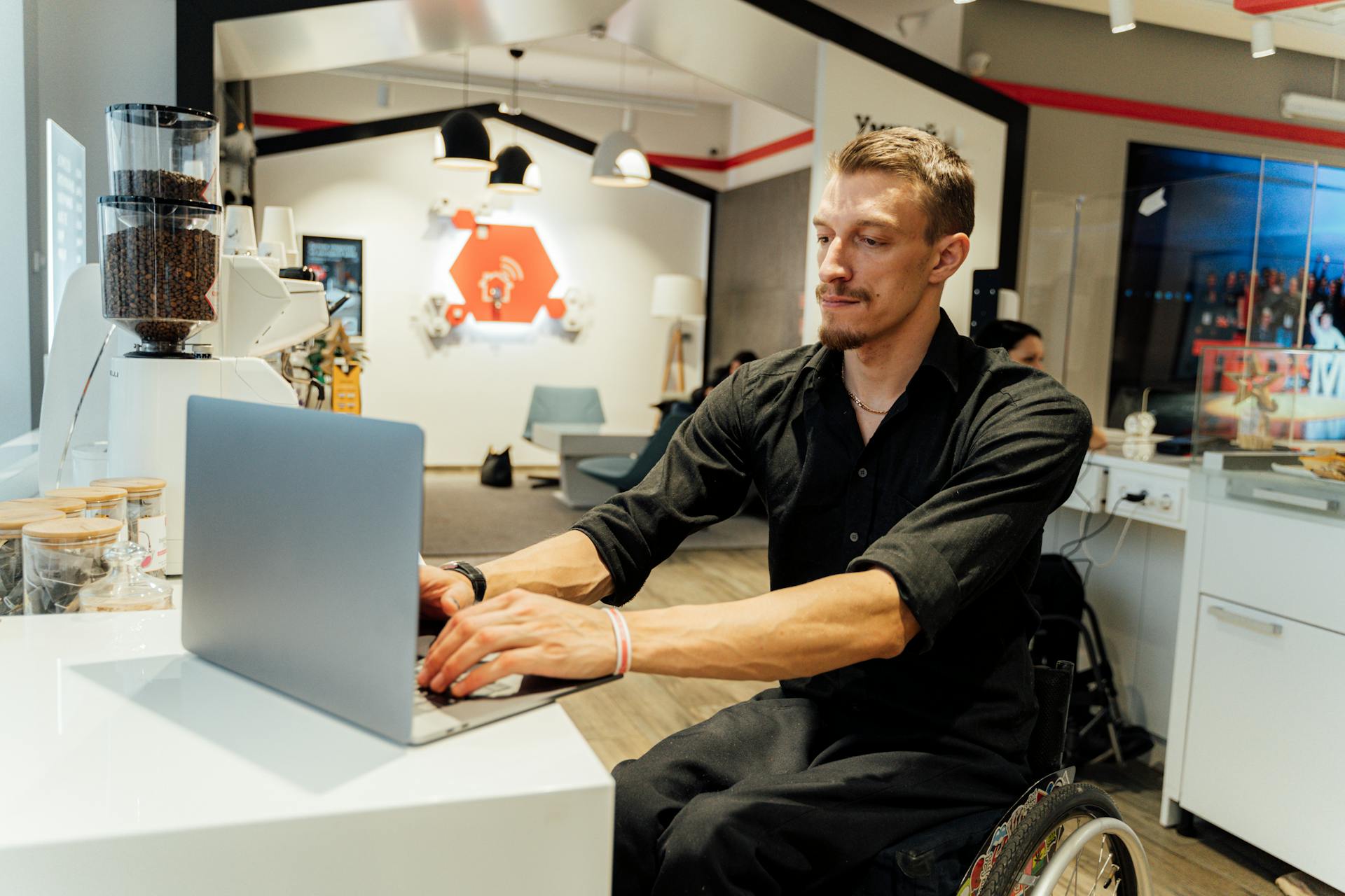 A Man in a Wheelchair Using a Laptop