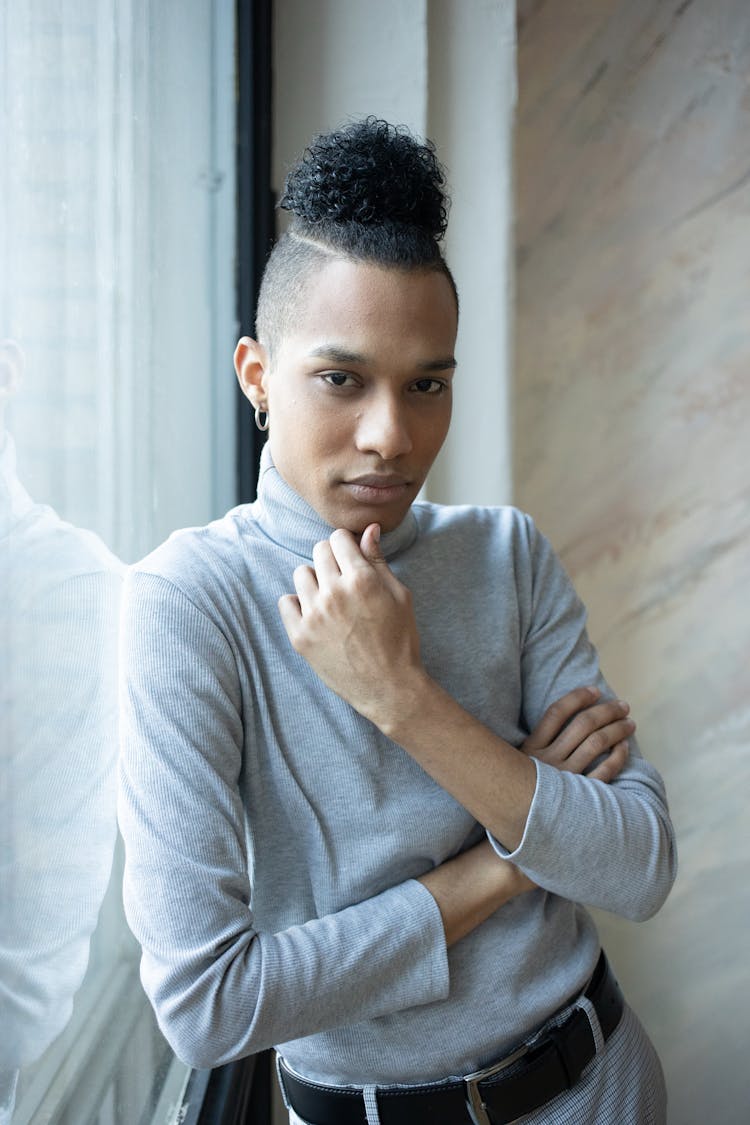 Stylish Ethnic Man Touching Chin In Studio