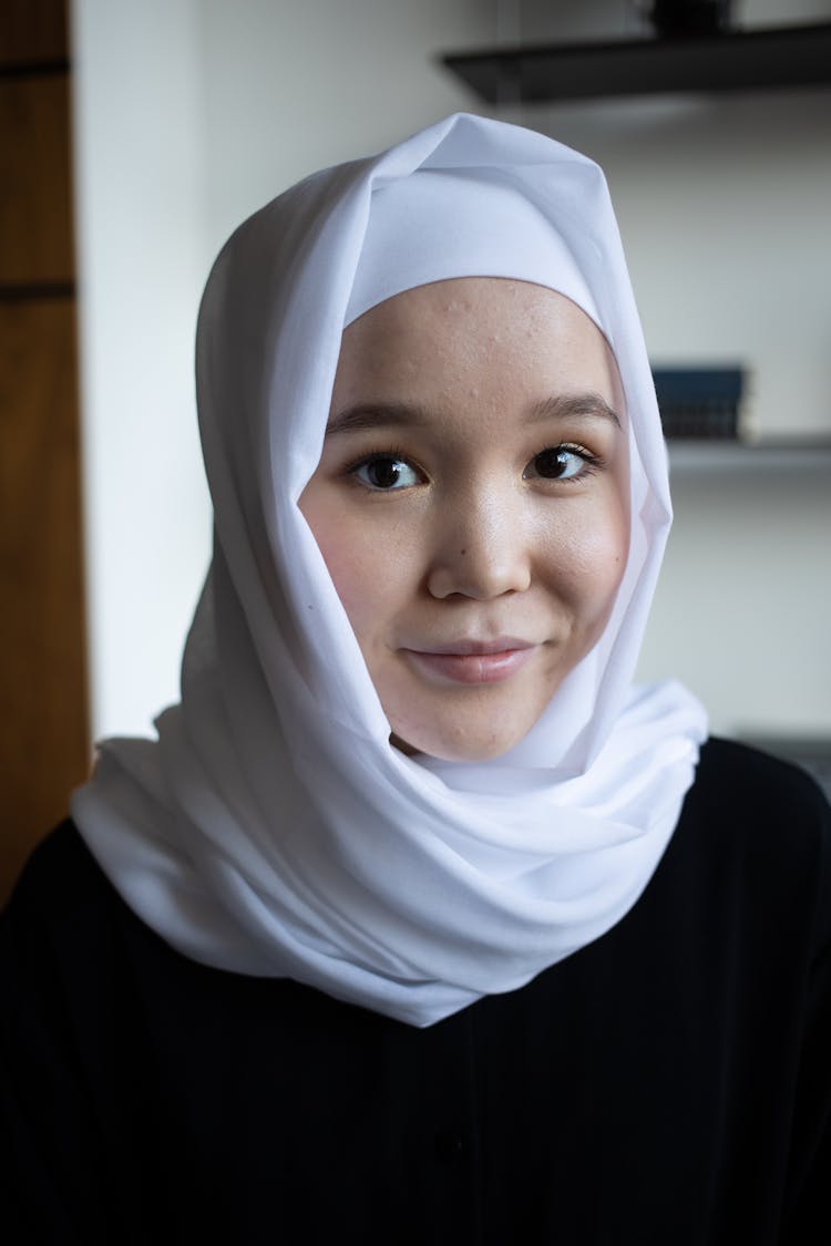 Positive Asian Woman In Hijab In Room