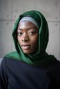 Islamic African American female in hijab near wall