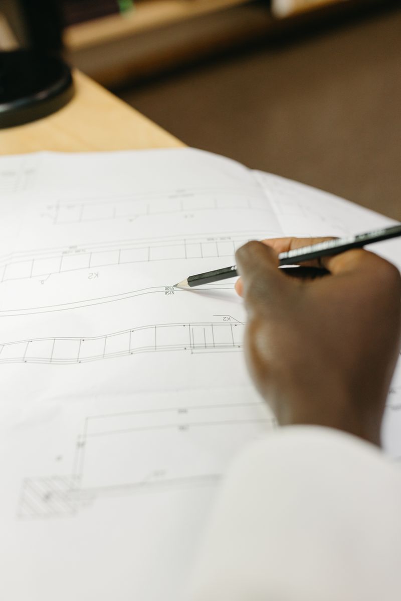 Hand drafting a blueprint in a workspace