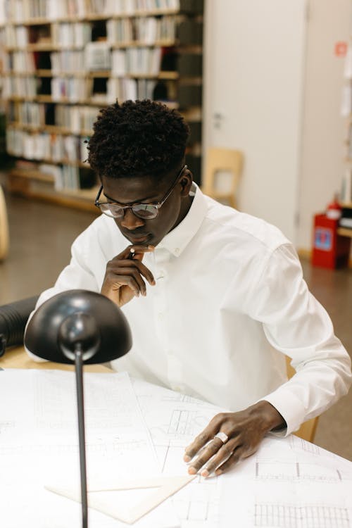 Pensive Man looking at Plans 