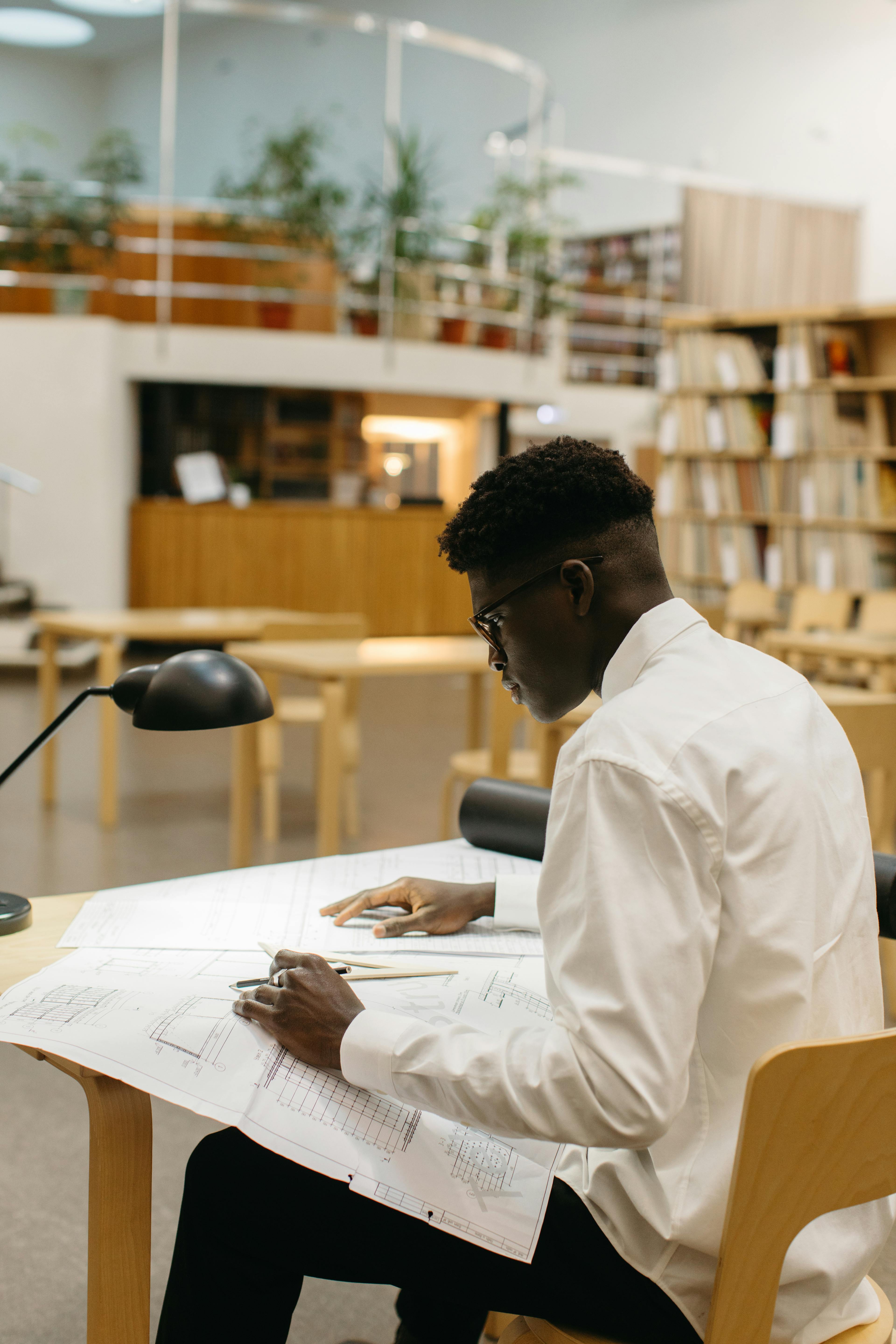 A Man Studying Inside the Library