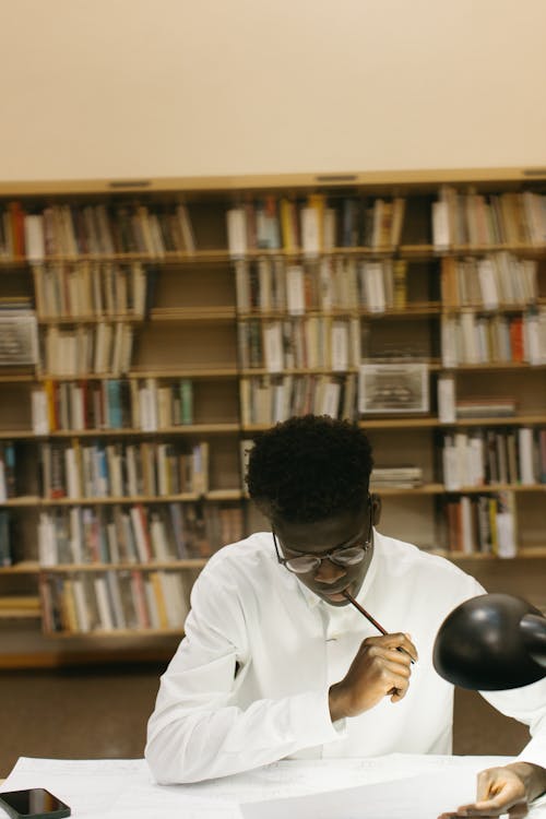 A Man Studying while Looking at the Table