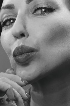 Close-up black and white portrait of a woman with expressive eyes.