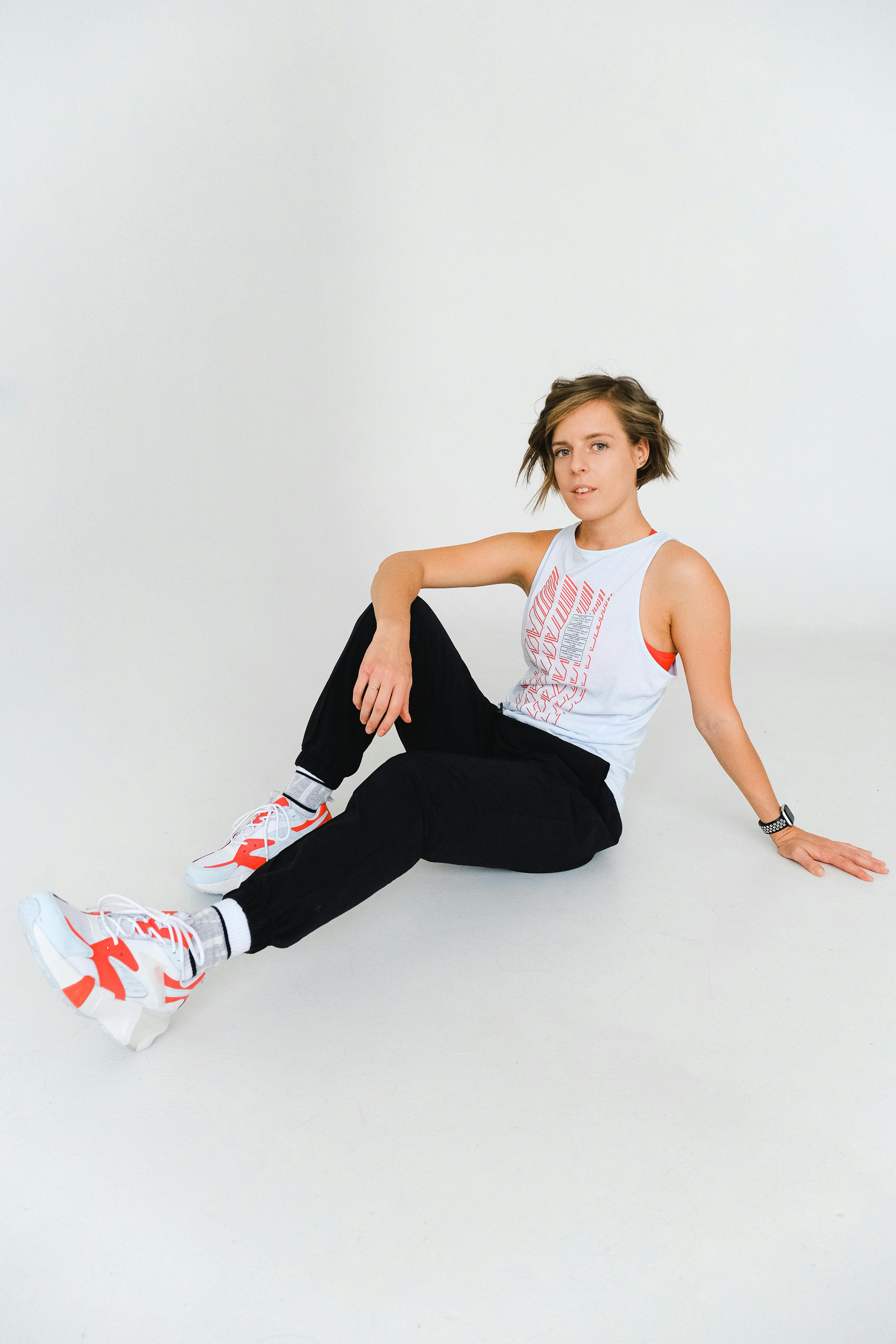 woman sitting on floor wearing sportswear