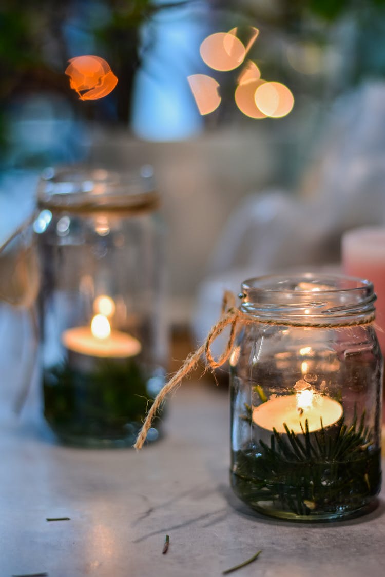 Lit Tealight Candles In Glass Jars