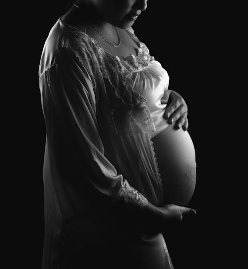 Pregnant Woman in White Long Sleeve Dress