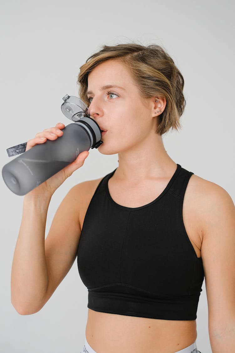 Woman Drinking Water From Reusable Bottle