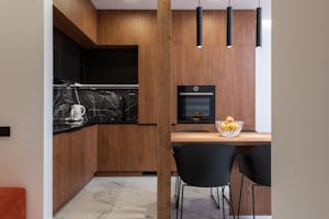 Wooden furniture and table in contemporary kitchen with dining zone