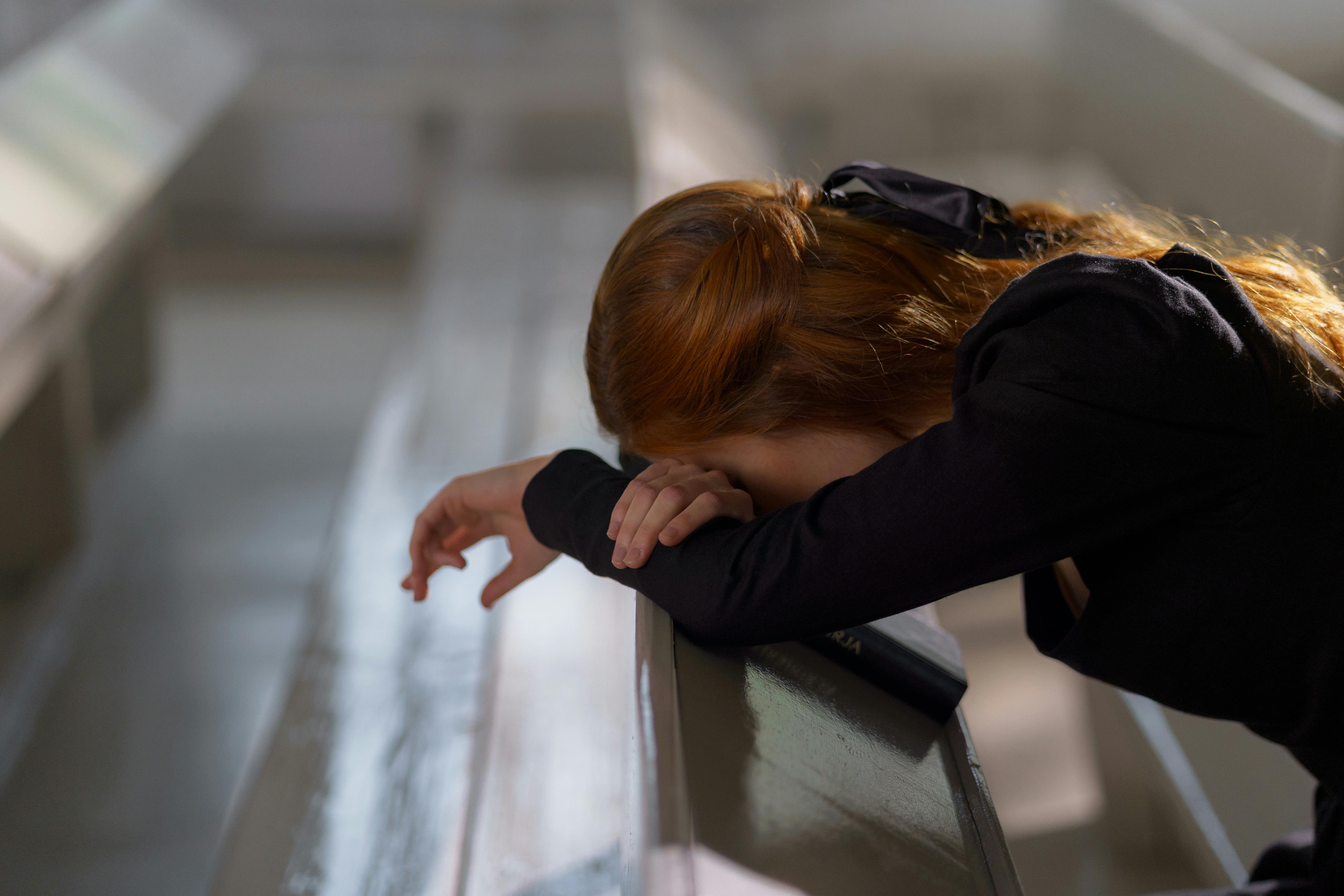 woman leaning on a bench