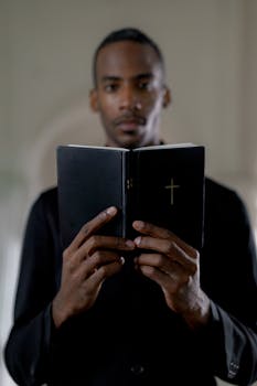 man in black suit holding black tablet computer