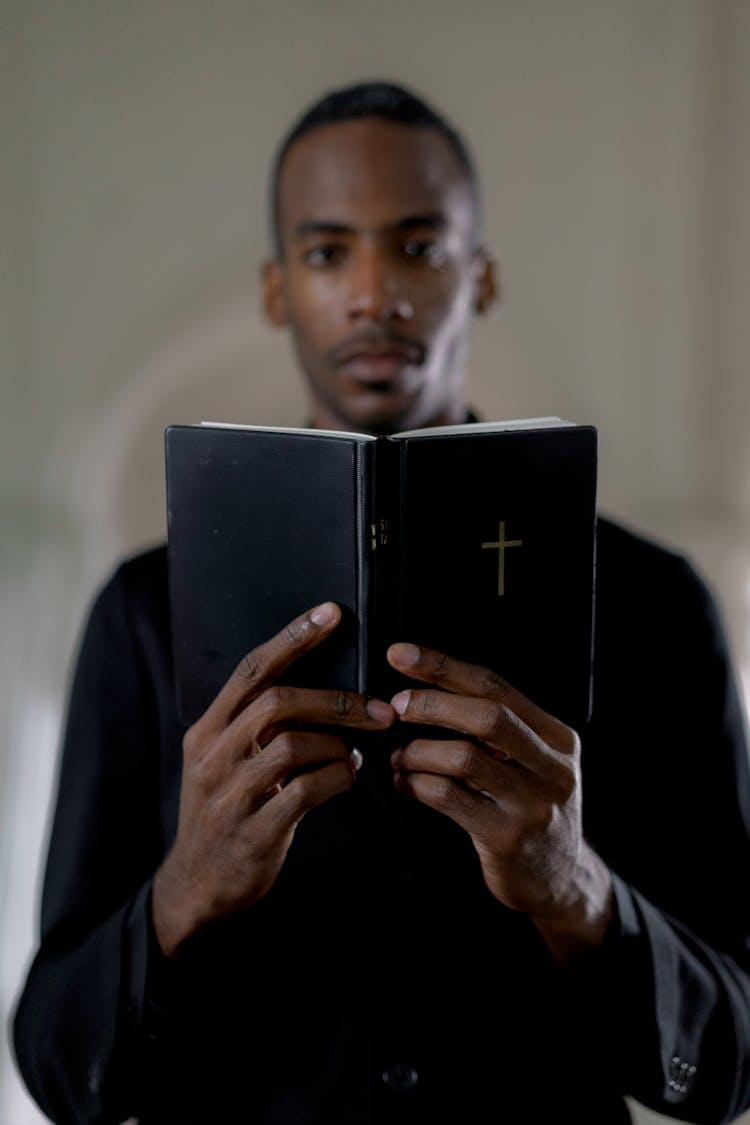 A Pastor Holding A Bible