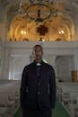 Man in Black Coat Standing Inside the Church