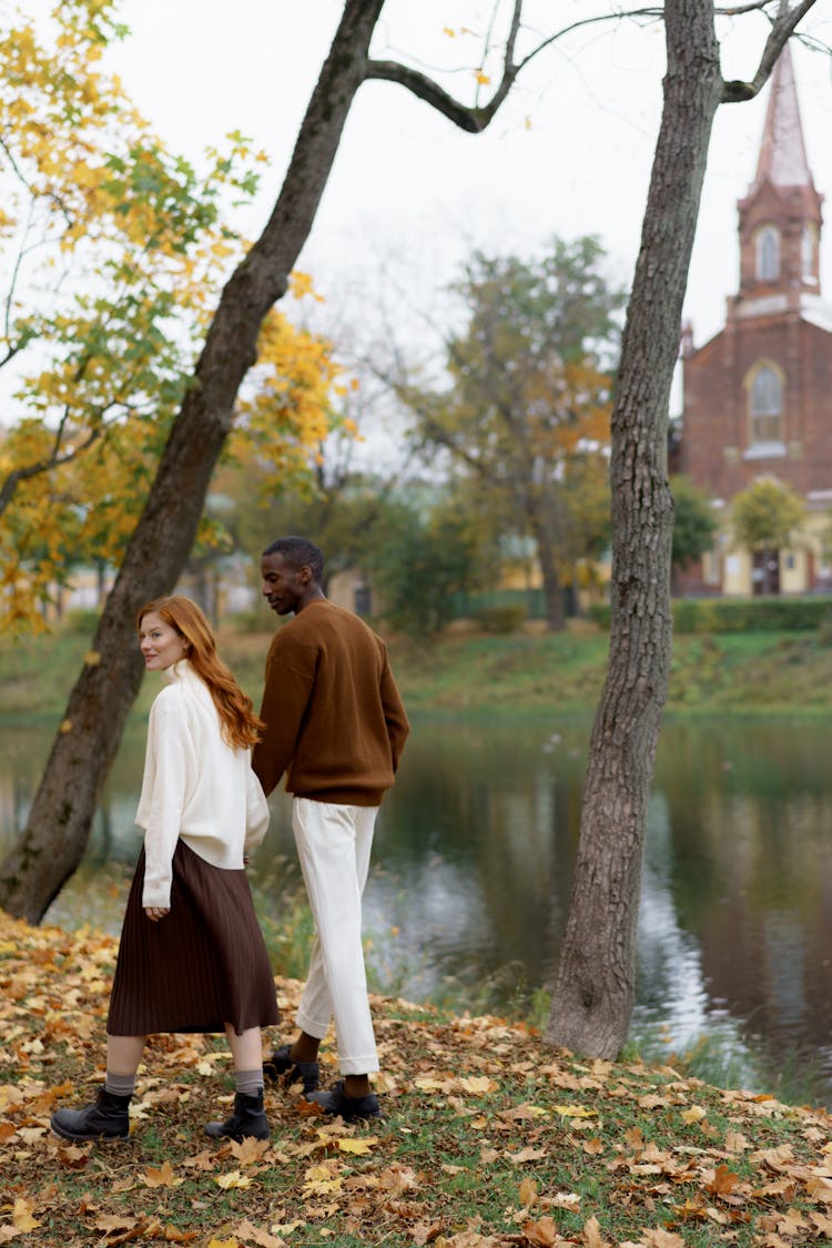 A Couple Walking Together Near A River