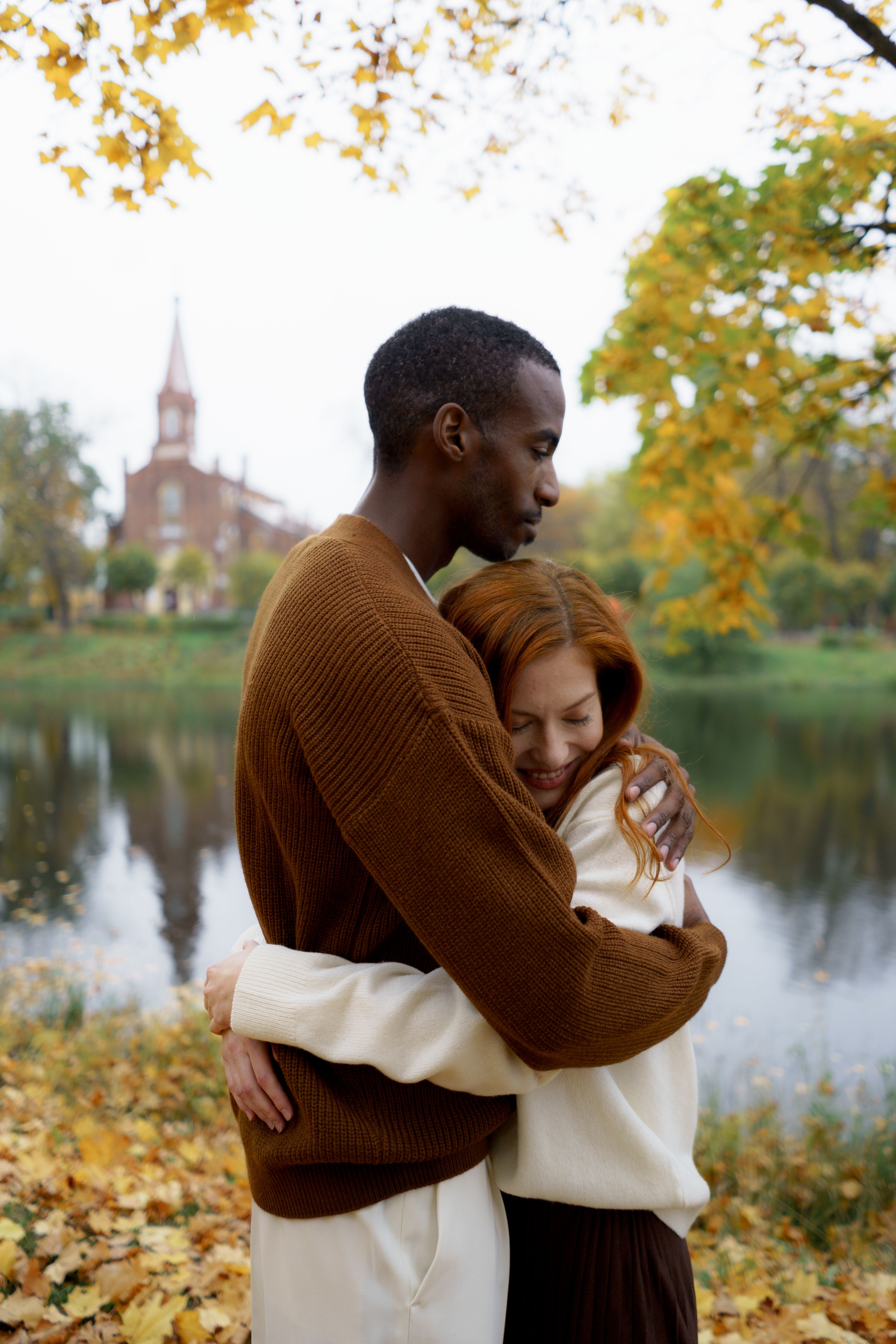 Man in Brown Sweater Hugging a Woman in White Long Sleeve Top · Free ...