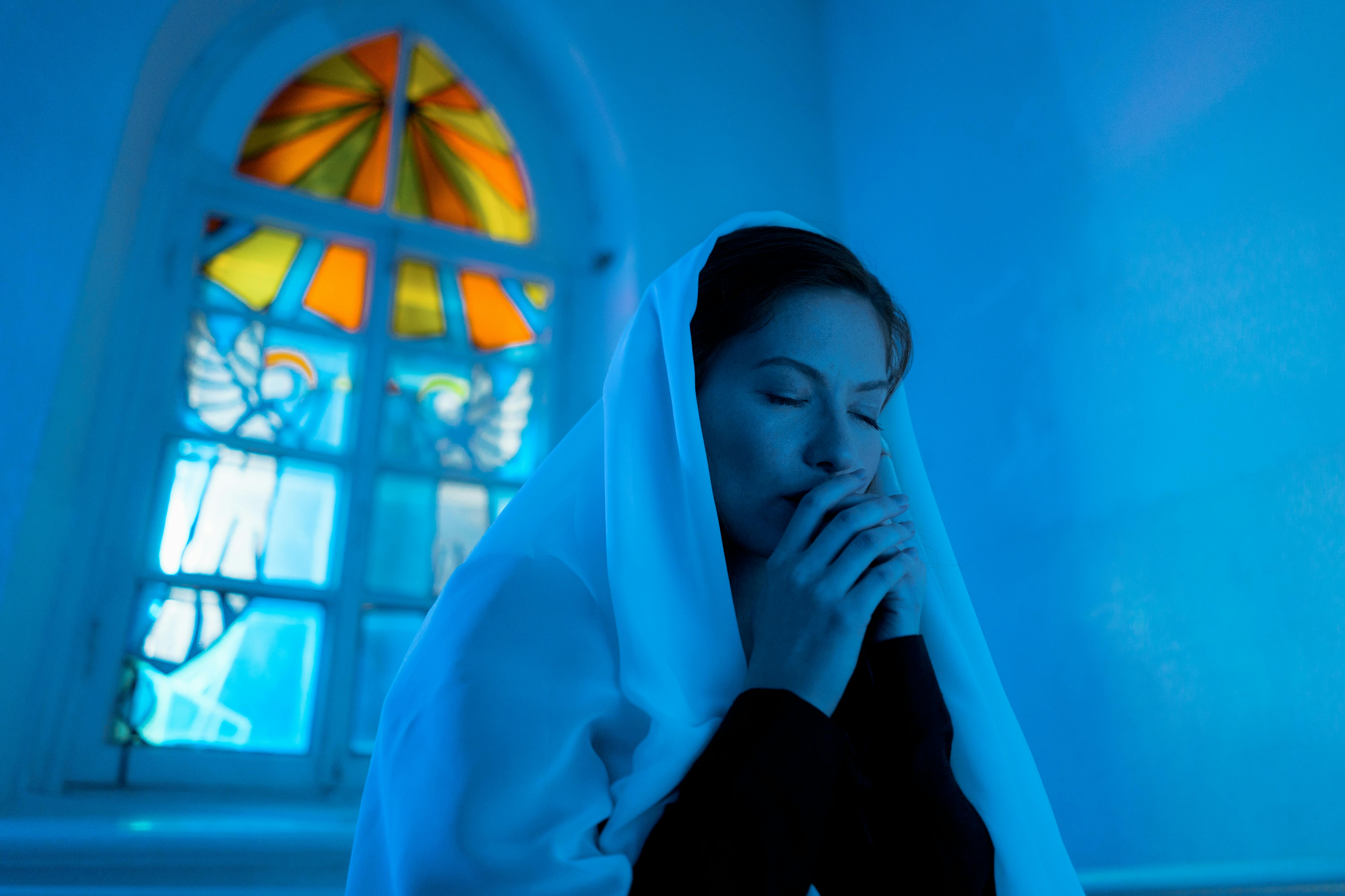 a woman praying inside the church