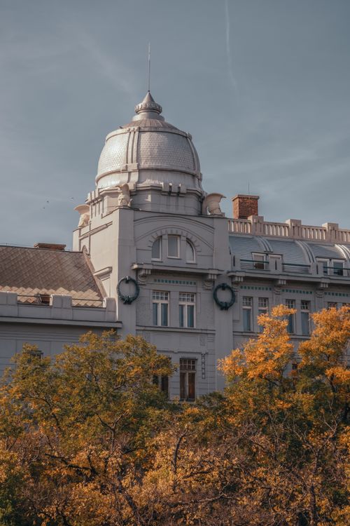 Free Elegant historic building with a dome in Bratislava, Slovakia, captured on a clear day with autumn foliage. Stock Photo