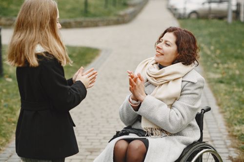 Free Mother and daughter sharing a happy moment outdoors, enjoying conversation together. Stock Photo