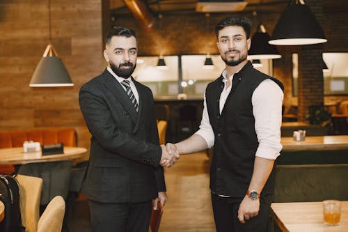 Men Shaking Hands and Posing for a Photo After a Business Meeting 