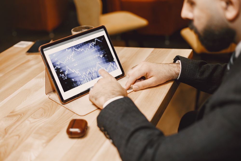 Profesional meninjau data keuangan melalui tablet