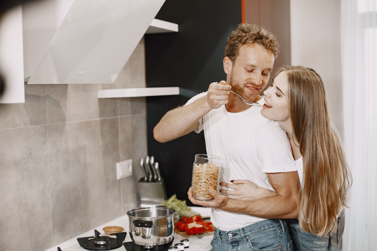 Two people preparing food together in a kitchen