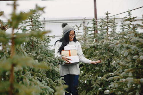 Woman among Christmas Trees