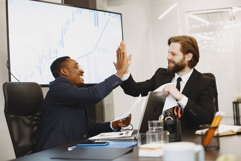 Colleagues celebrating a successful hire in the office