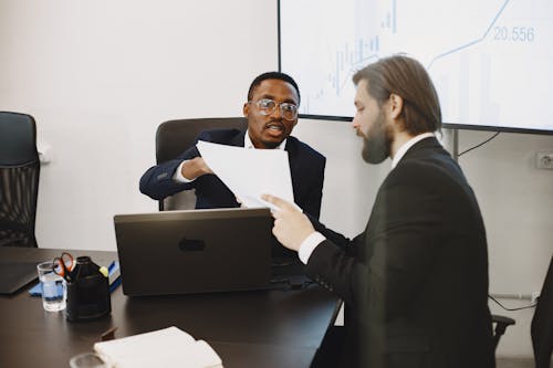 Businessmen Discussing over Documents