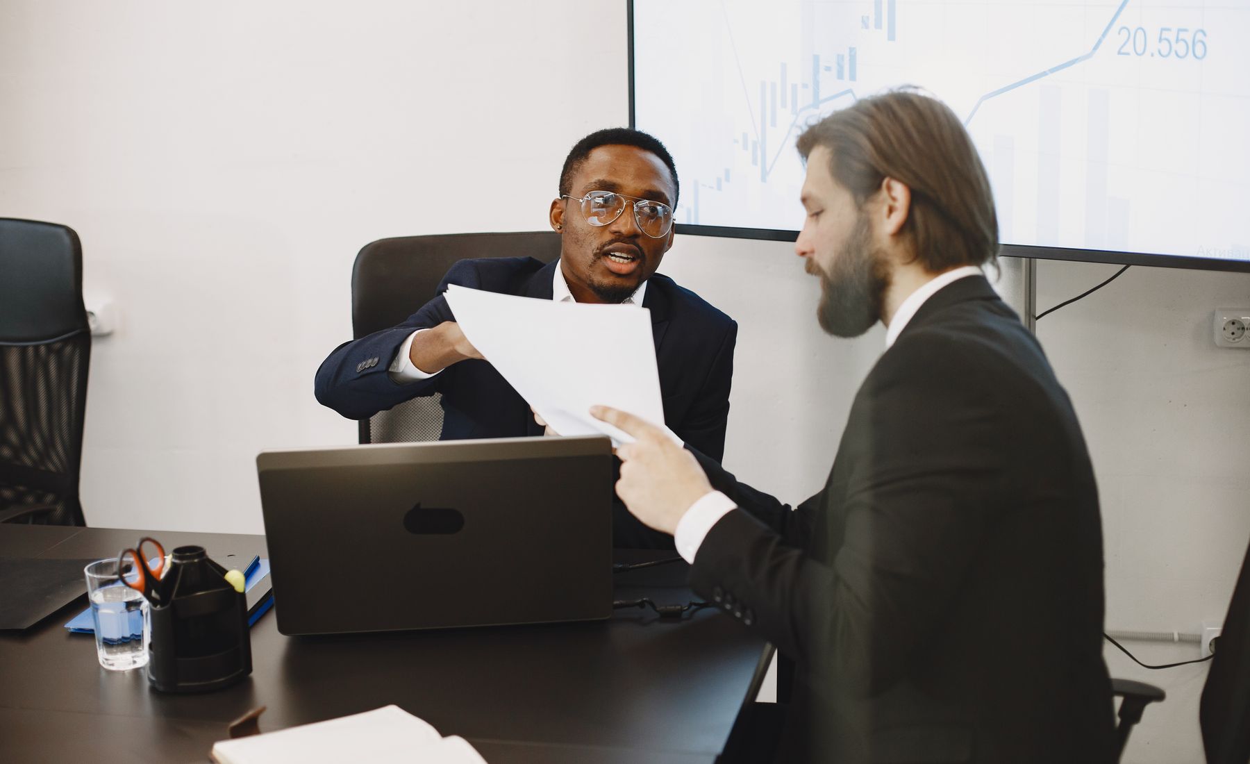 Executives reviewing documents and business data