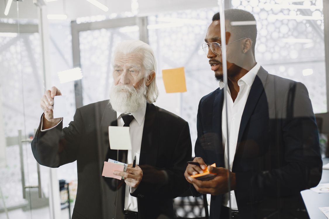 Men Looking at Sticky Notes · Free Stock Photo