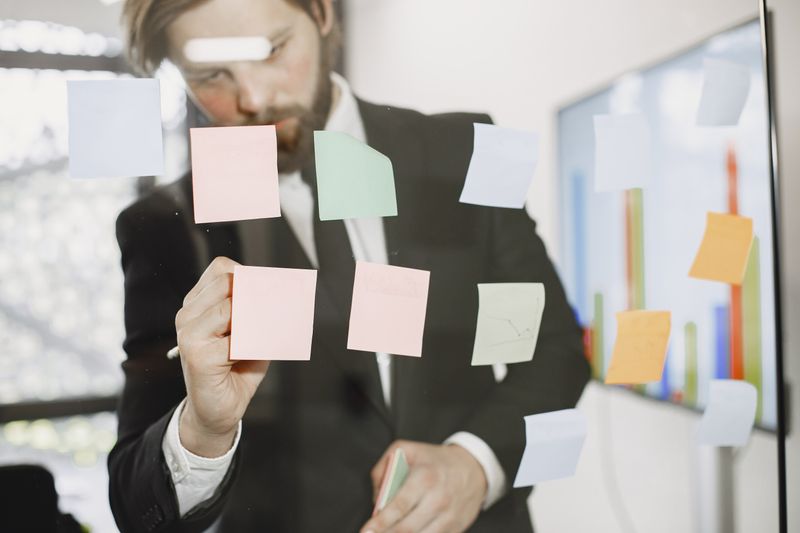 sticky notes tracking a debate on an office wall