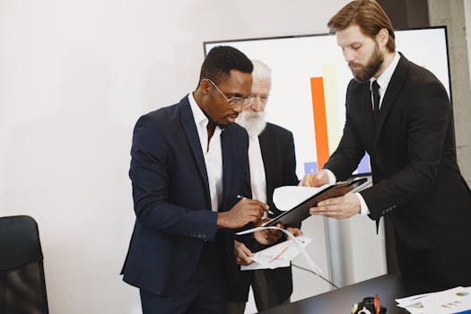 Three businessmen engaged in document signing in a modern office setting.