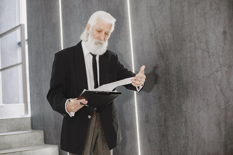 Senior Businessman Looking At Documents 