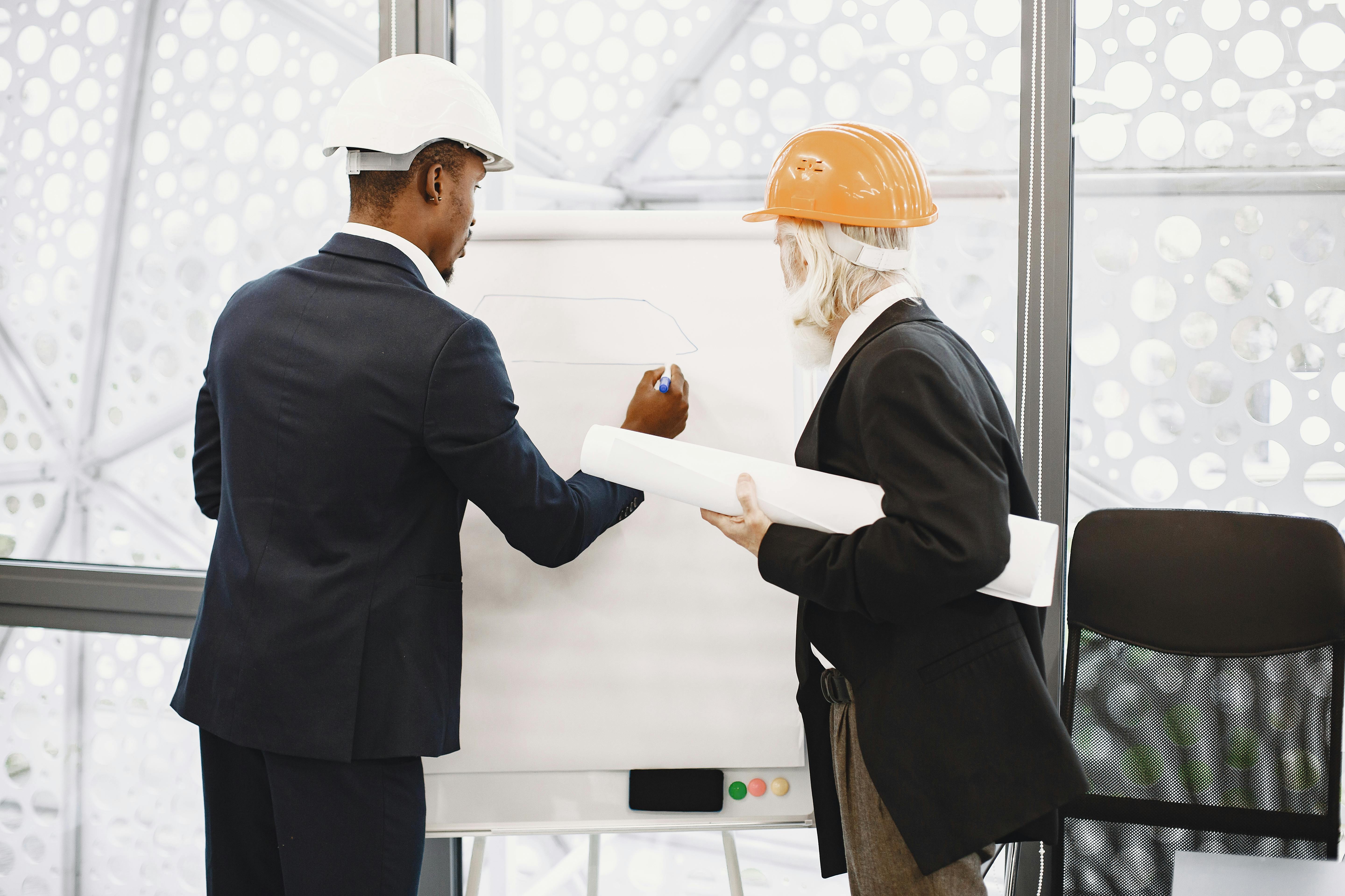 men reviewing architectonic plans together